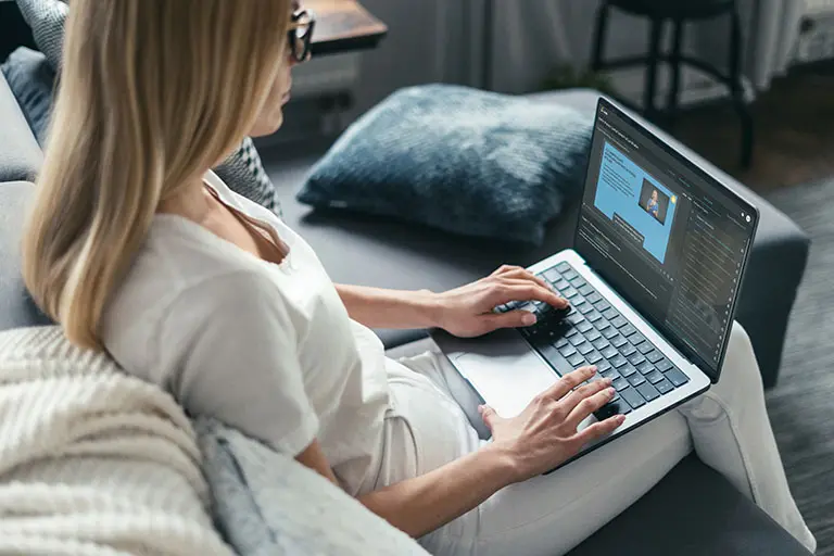 Woman on couch with laptop